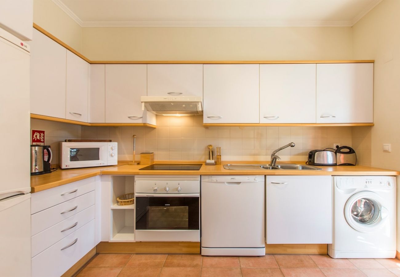 Spacious and fully equipped kitchen with dining area.