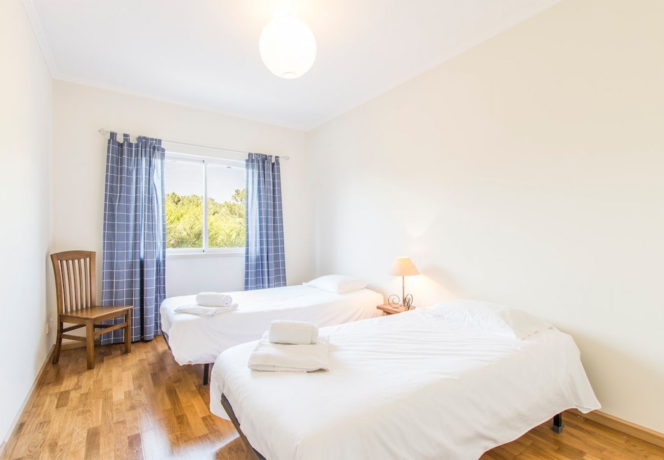 Room with two beds and natural light.