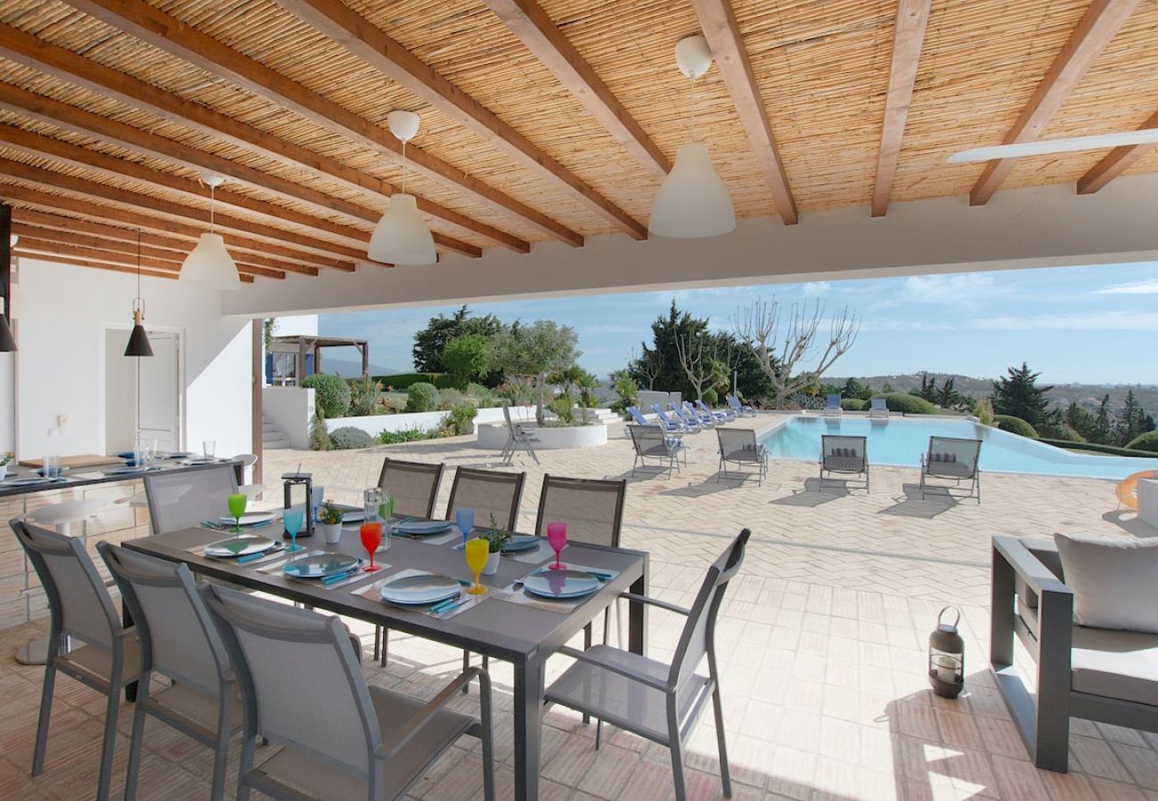 Dining area in the outdoor space overlooking the pool.