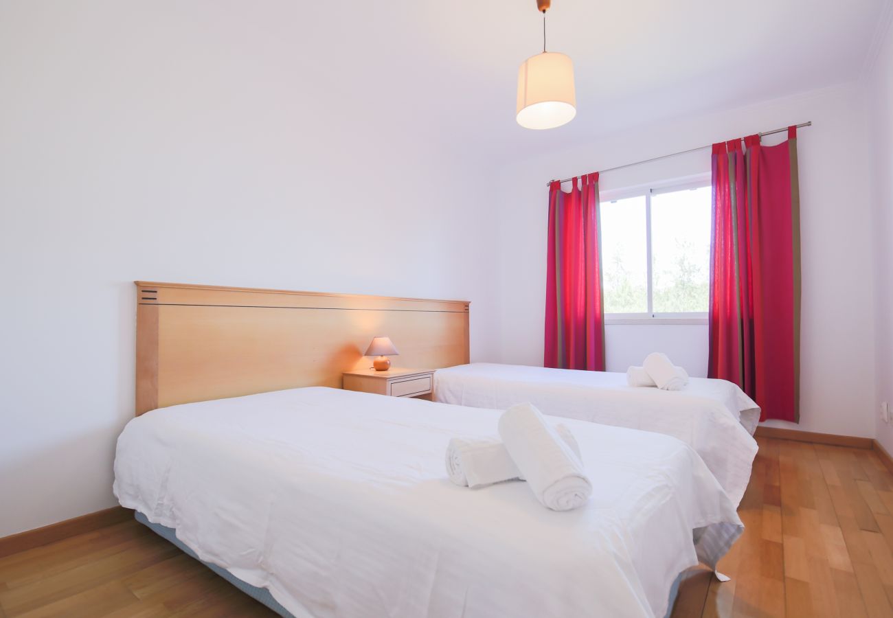 Room with two beds and natural light.