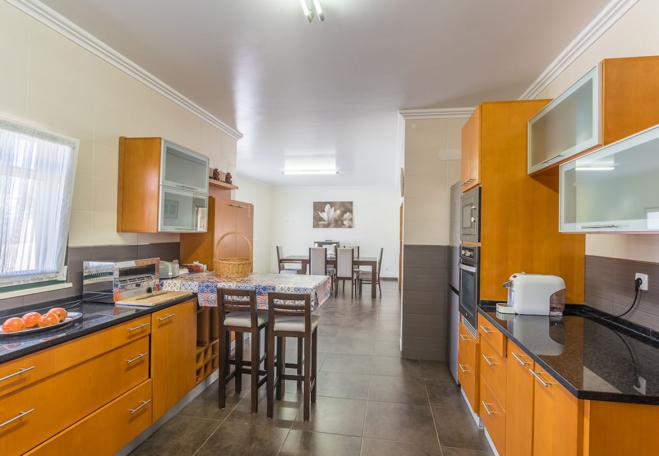 Spacious and fully equipped kitchen with dining area.