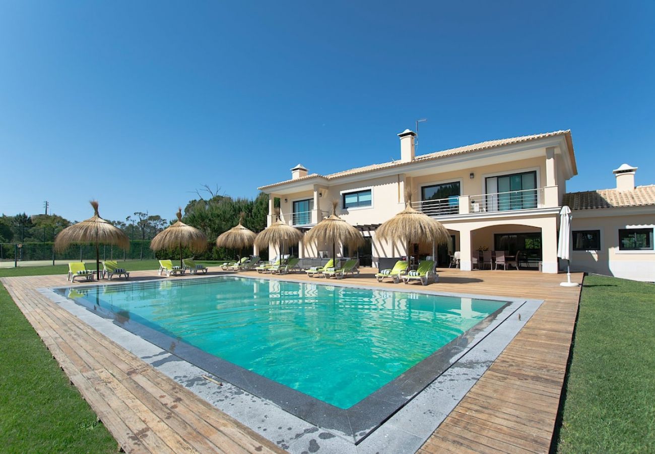 Holiday villa with surrounding garden and swimming pool.