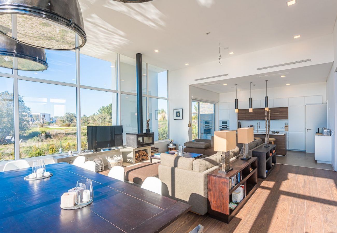 Living room surrounded by glass and with a stunning view.