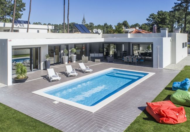 House surrounded by outdoor space, with swimming pool and garden.