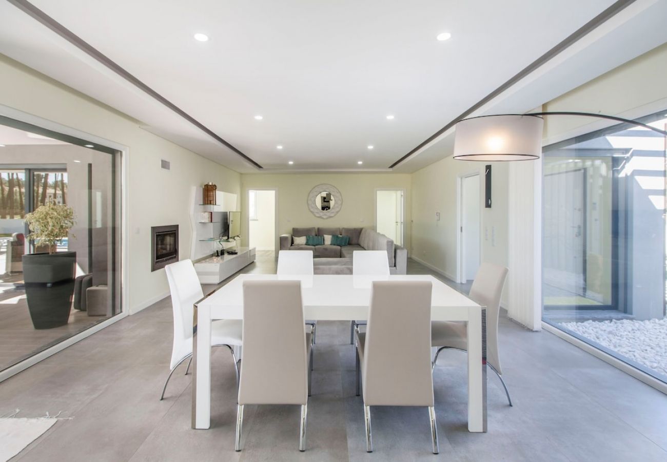 Living and dining room with access to outdoor space.