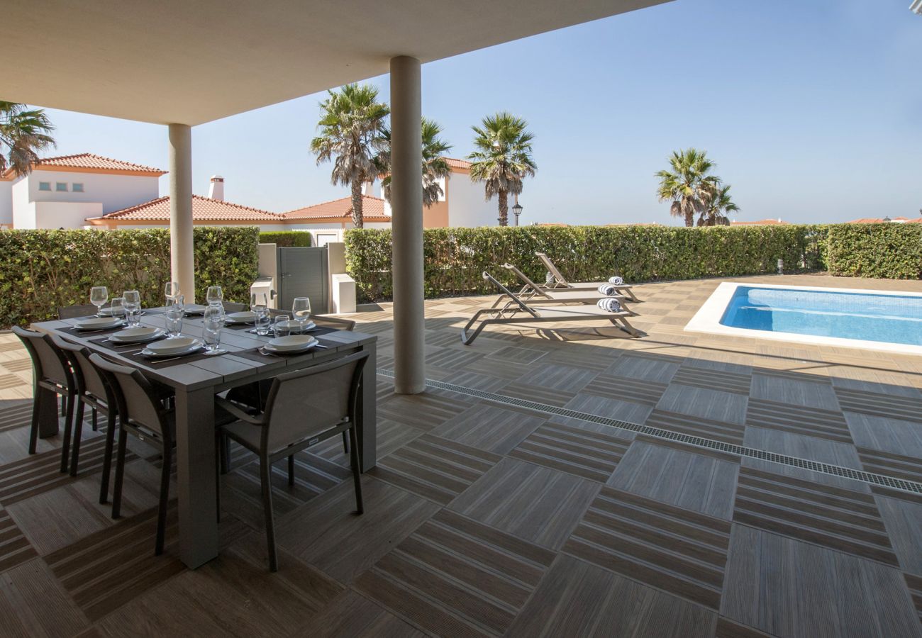 Outdoor dining area overlooking the pool.